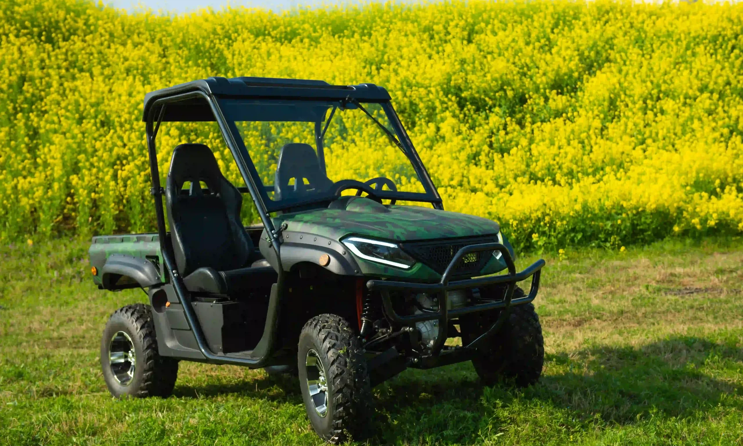 electric UTV in a field of rapeseed flowers
